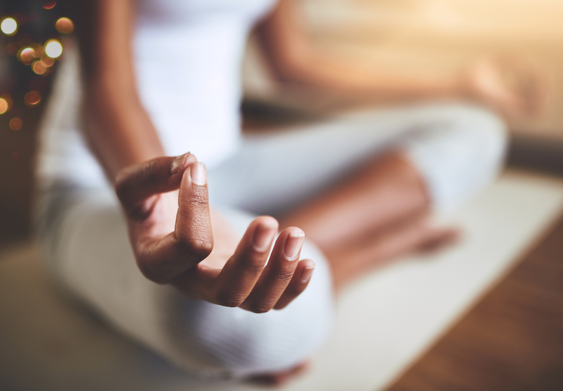 Person meditating, symbolizing the management of stress and its physiological impact on cardiovascular health at Cardiac Longevity Clinic.